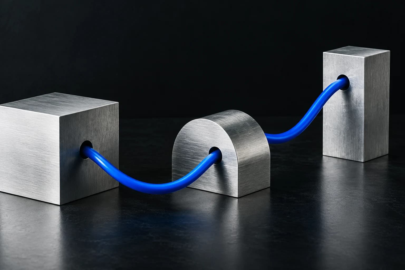 Blue cable connecting sculptural metal blocks into a single system